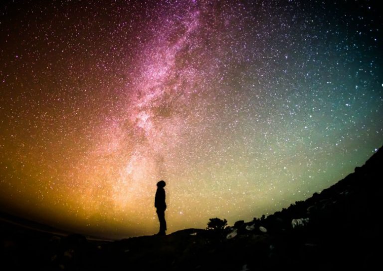 man staring at stars, astrological destiny