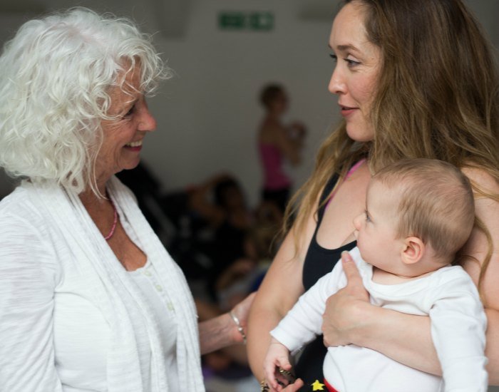 Lolly Stirk with lady holding baby triyoga