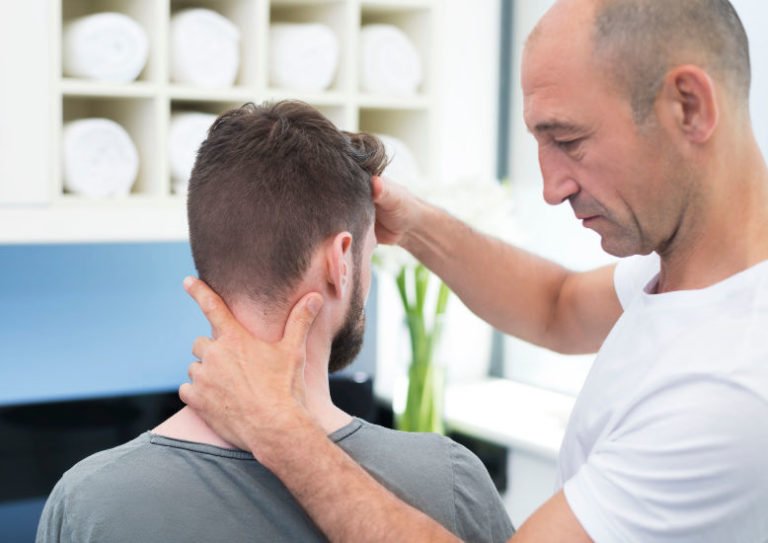 osteopath treating man's neck