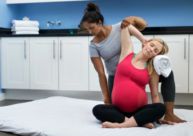 women giving pregnancy massage triyoga