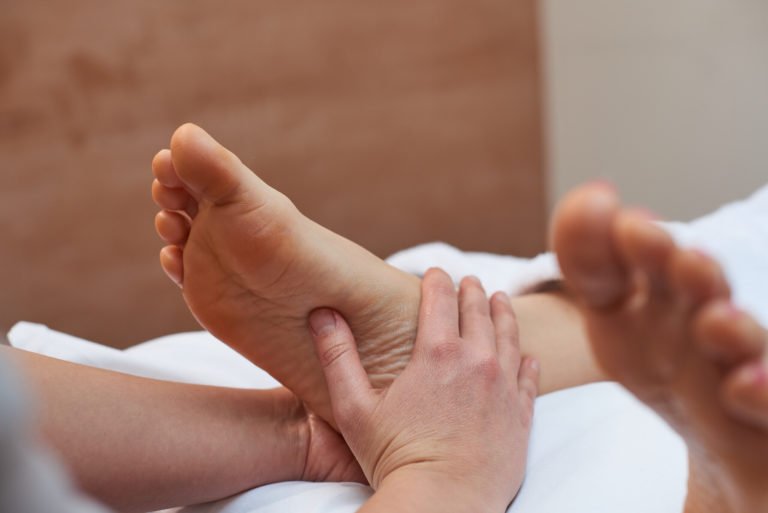 feet receiving guided reflexology for stress triyoga treatments