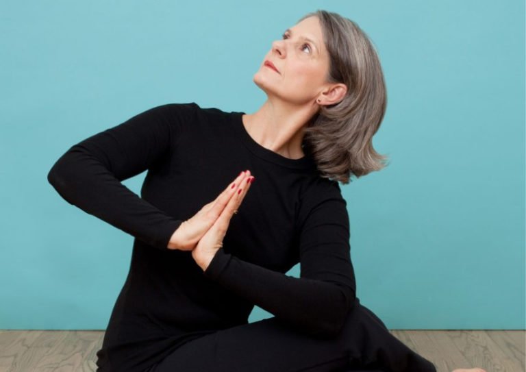 woman doing seated yoga posture mindfulness meditation Cyndi Lee triyoga
