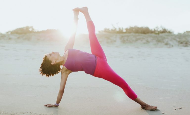 yoga therapeutics teacher Amy Ippoliti practising yoga on beach