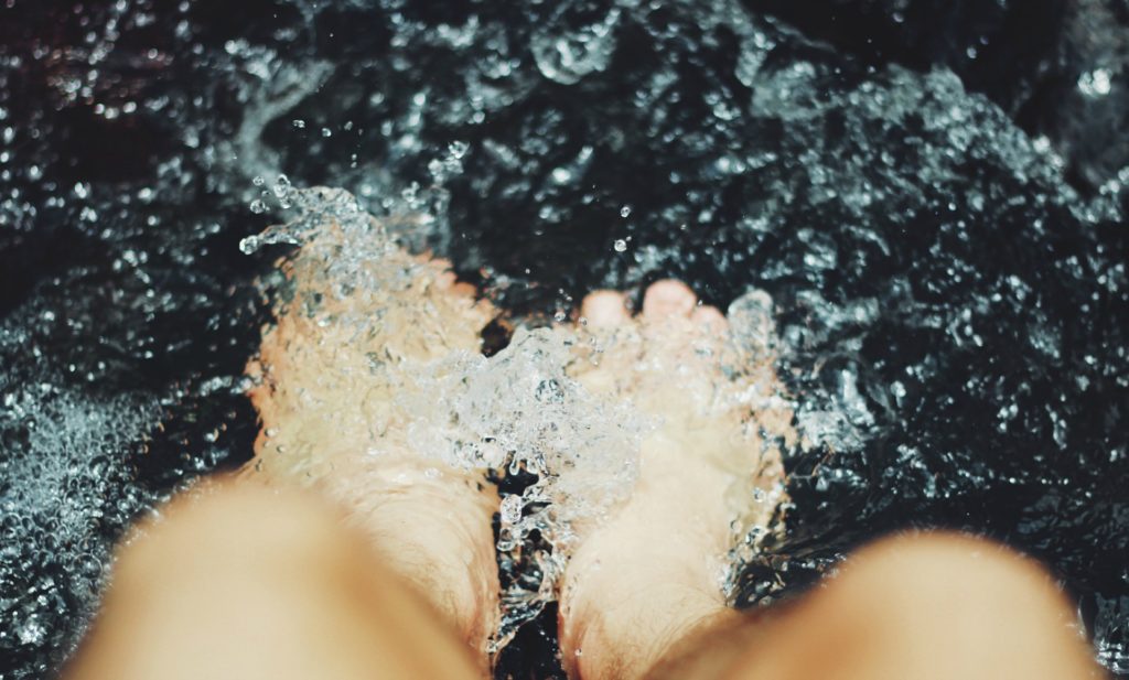 two feet soaking in water