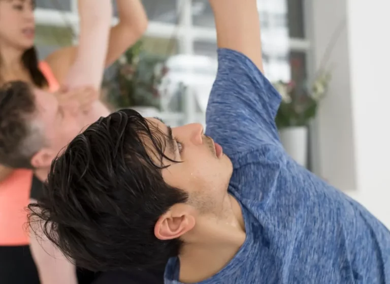 A man practicing hot yoga in a triyoga studio in London