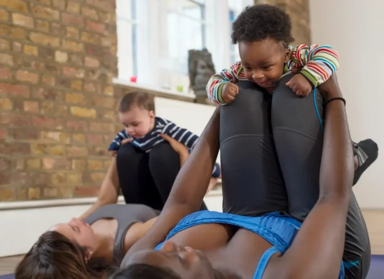 moms practising baby yoga