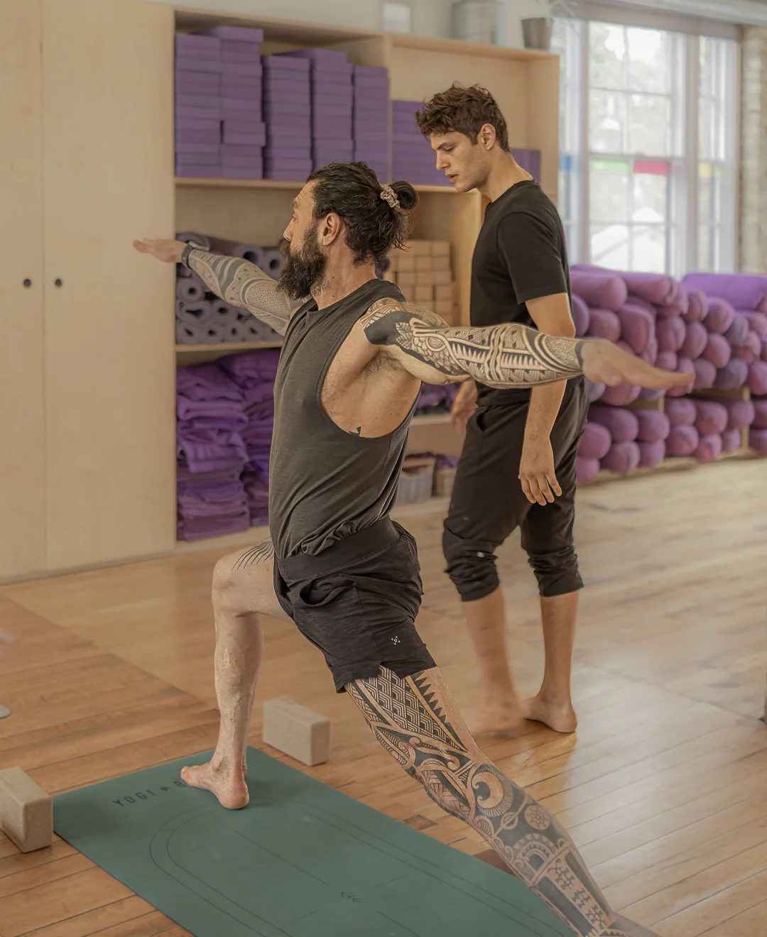 Men practising yoga in studio
