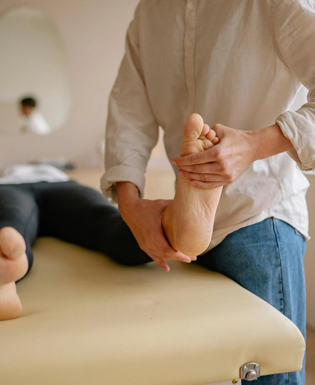 Person receiving foot massage therapy