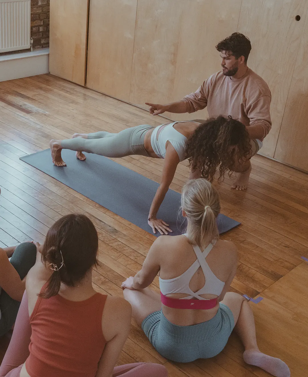 Yoga class with instructor and students