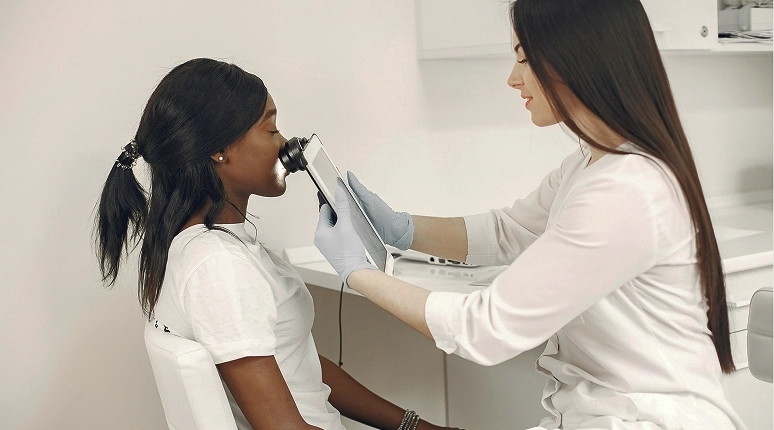 Woman receiving facial treatment consultation
