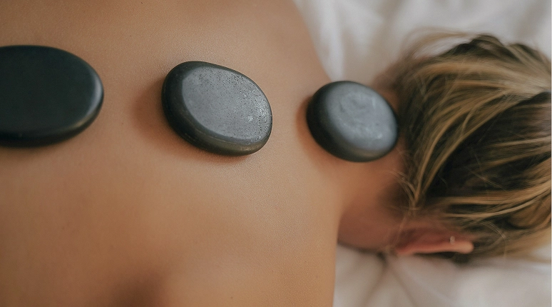 Hot stones on a person's back