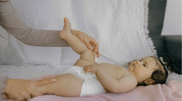 Baby lying down, playful interaction.