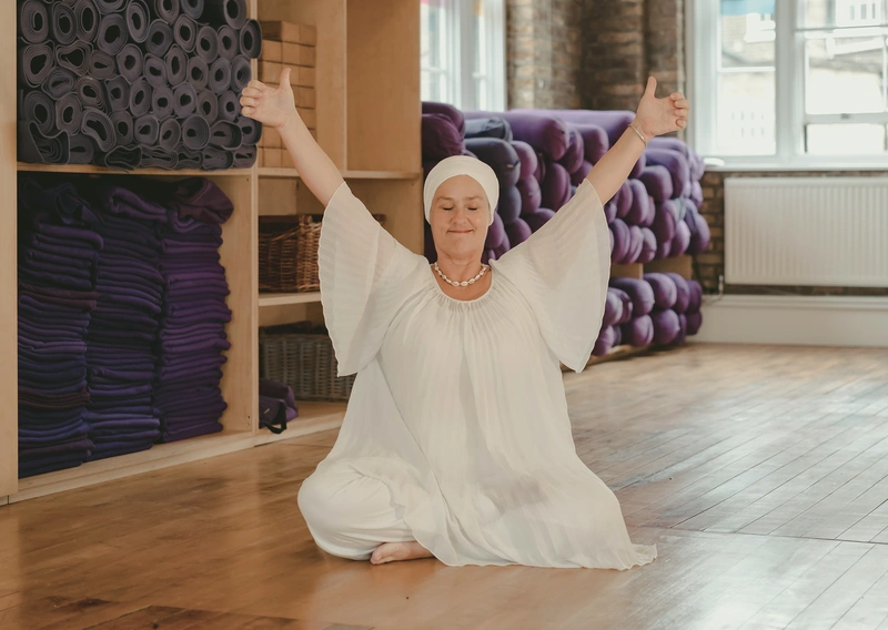 Woman practising yoga in white attire