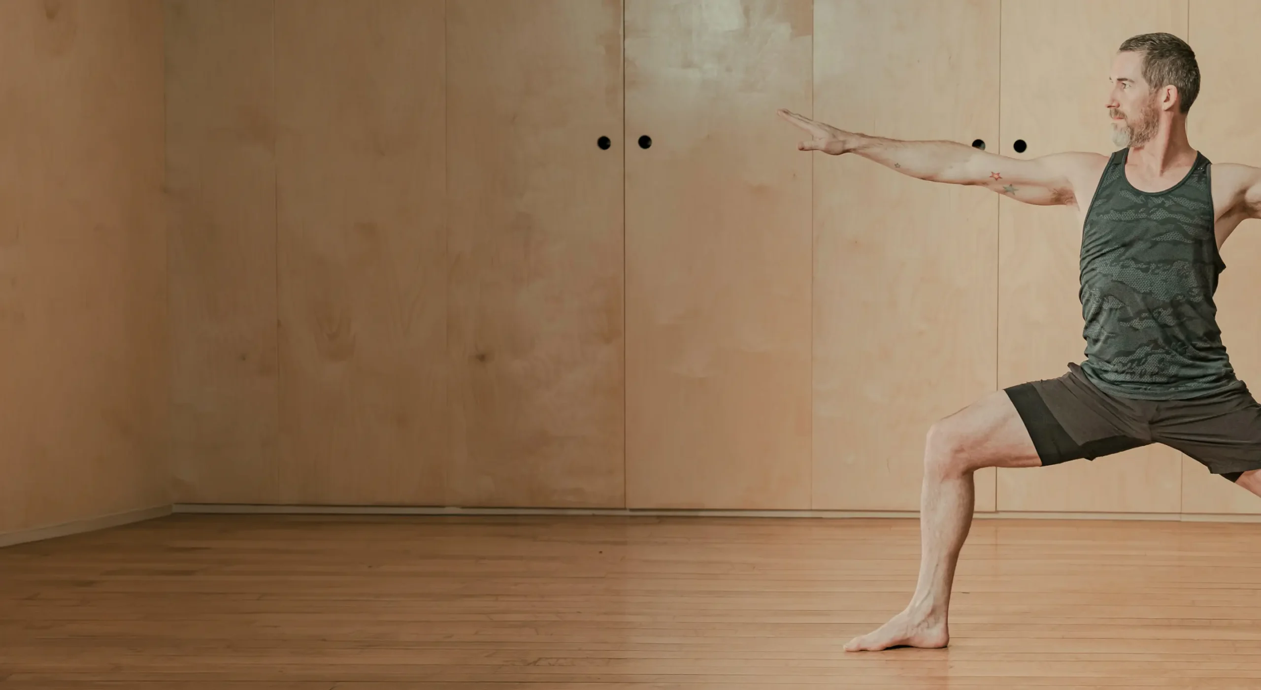 Man performing yoga in a studio