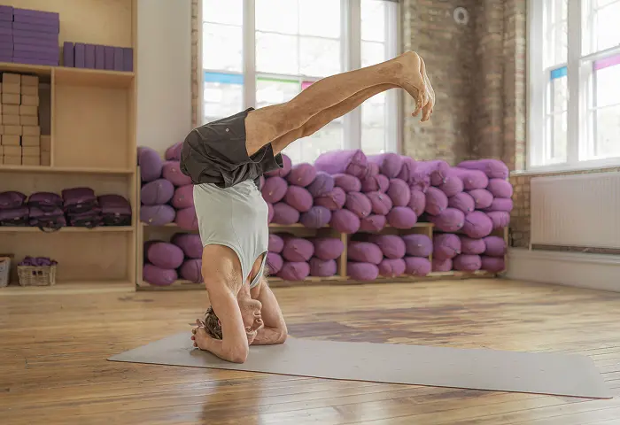 Person performing yoga headstand pose