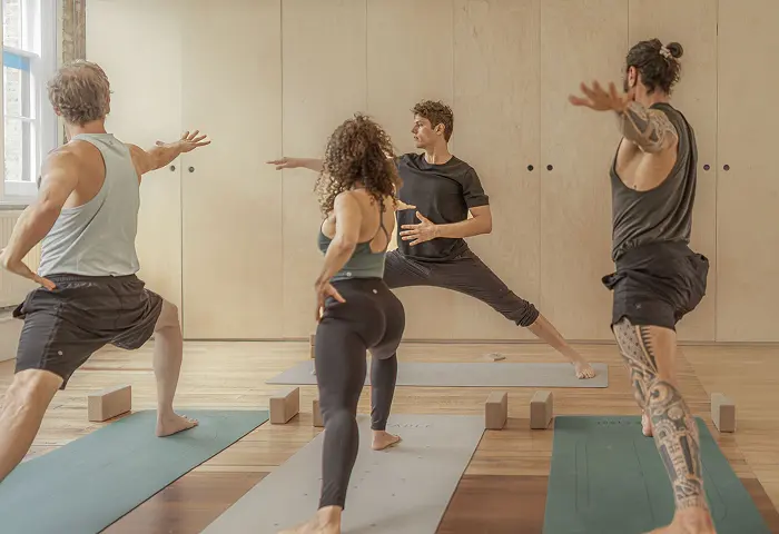 Group practising yoga in studio