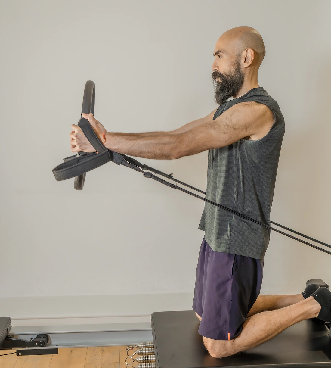 Man exercising on a reformer machine