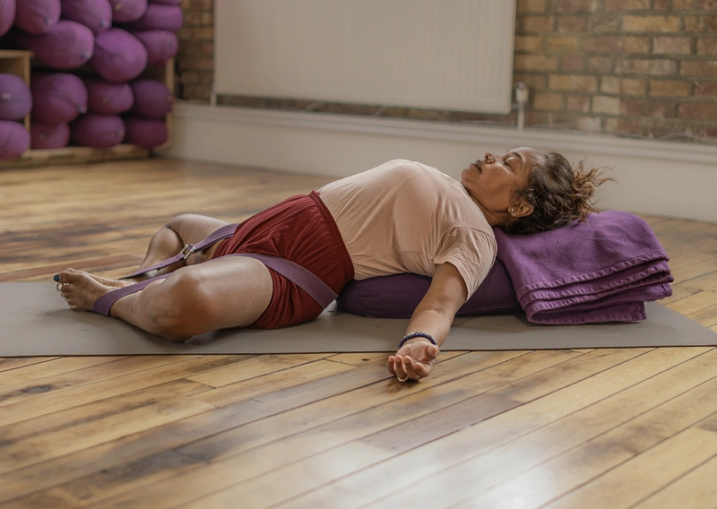 Person practising yoga in relaxation pose